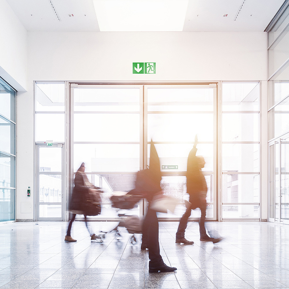 blurred commuters at a modern corridor